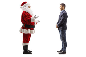 Full length profile shot of santa claus talking to a young man