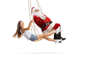 Full length profile shot of a happy girl and santa claus swinging on swings