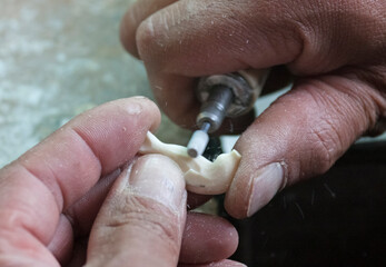 Local artist carving on walrus tusk, Uelen village, the most northeastern village in Russia,...