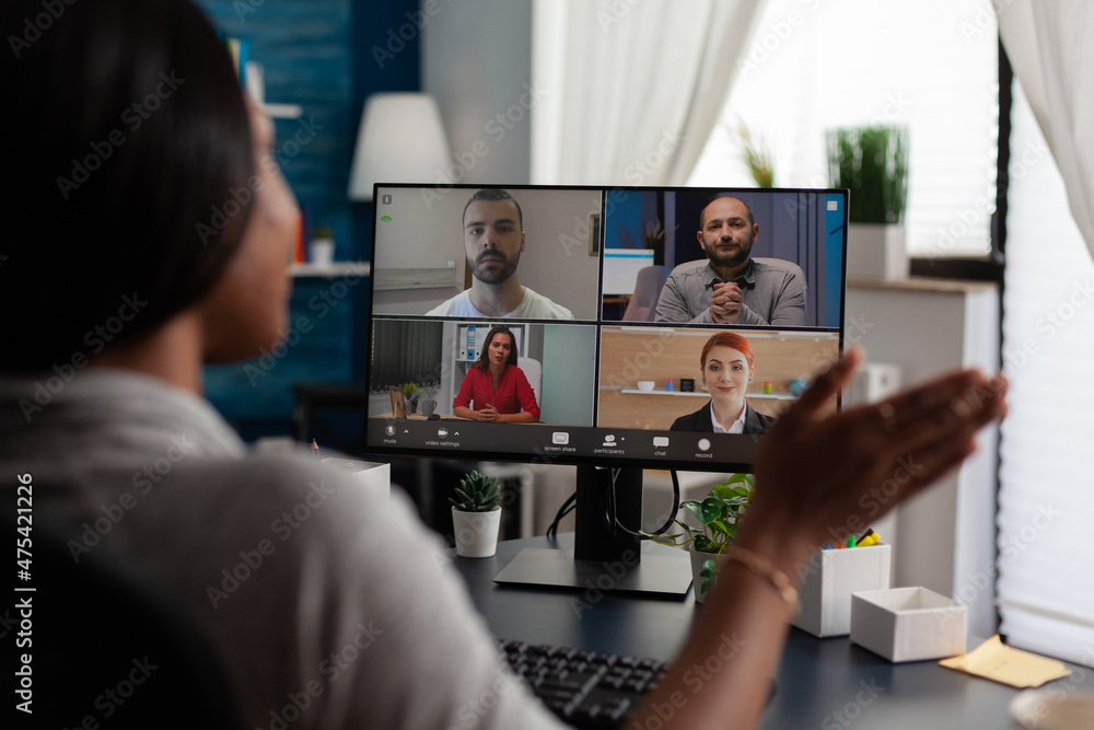 Poster entrepreneur using video call with colleagues to do business meeting and remote work on computer. wo