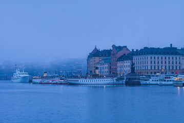 Fototapeta na wymiar Sweden, Stockholm, Gamla Stan, Old Town, old town skyline, morning fog