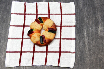 The roscón, rosca de Reyes or king cake is a sweet dough bun decorated with candied or crystallized fruit, with figurines inside for January 6, Three Kings Day.
