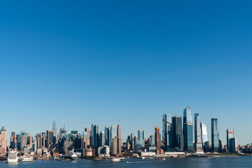 Fototapeta na wymiar New York City skyline from New Jersey over the Hudson River with the skyscrapers of the Hudson Yards district at day time. Manhattan, Midtown, NYC, USA. A vibrant business neighborhood