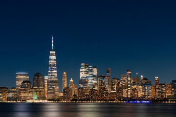 Fototapeta na wymiar Skyline of New York City Financial Downtown Skyscrapers at night. Manhattan, NYC, USA. A vibrant business neighborhood