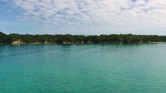 Strafe Aerial of Escudo Island with Tropical Jungle and Blue Water