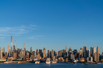 Aerial New York City skyline from New Jersey over the Hudson River with the skyscrapers of the Hudson Yards district at sunset. Manhattan, Midtown, NYC, USA. A vibrant business neighborhood