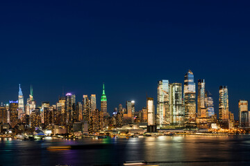 Fototapeta na wymiar Aerial New York City skyline from New Jersey over the Hudson River with the skyscrapers of the Hudson Yards district at night. Manhattan, Midtown, NYC, USA. A vibrant business neighborhood