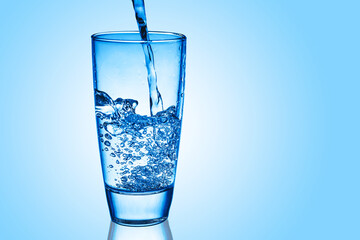 Mineral water background. Pouring water into glass. Drinking water fizzy bubble. Sparkling water glass.	Benefits of drinking water.