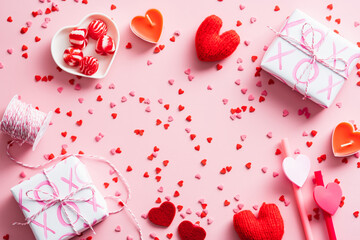Happy Valentines Day composition. Flat lay gift boxes, red hearts, candles, confetti on pink background. Love, romance concept.