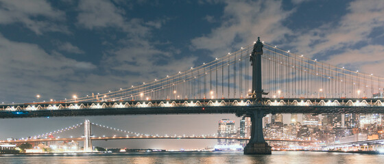 Cloudy sky over the New York's Manhattan and Brooklyn bridges