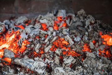 Closeup of burning and flaming hot coal in the fireplace