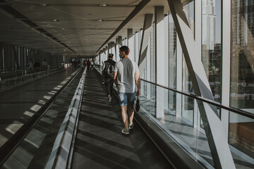 Young adult using respiratory protection with wearing cloth mask on face and walking on escalator indoor with social distancing