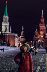 tourist girl on Red Square near Spasskaya Tower, Kremlin, Moscow city, Russia
