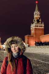 tourist girl on Red Square near Spasskaya Tower, Kremlin, Moscow city, Russia