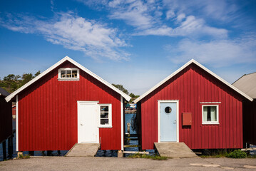 Fototapeta na wymiar Sweden, Bohuslan, Hamburgsund, red fishing shacks