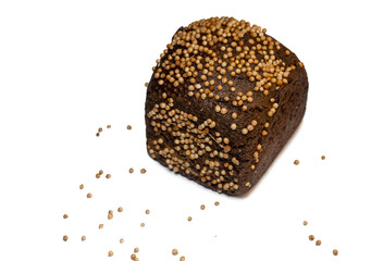 Black bread sprinkled with coriander. Borodino bread.  Bread with spices on white background