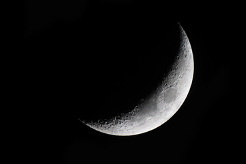 Obraz na płótnie Canvas The Waxing Crescent Moon starts as the Moon becomes visible again after the New Moon conjunction when the Sun and Earth are on opposite sides of the Moon