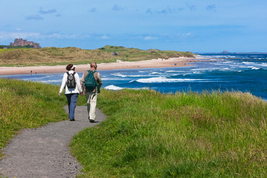 Tourists hiking along the coast of Northumberland, England, UK