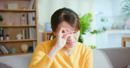 woman rubbing her eyes