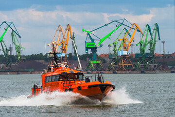 Fototapeta premium Boat and cranes in the harbor, Klaipeda, Lithuania