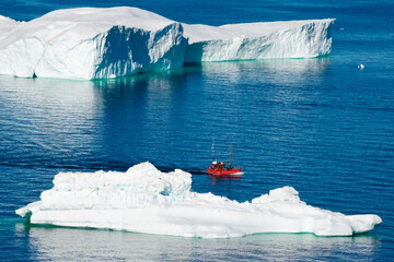Boat approaching Icebergs of Sermermiut, Ilulissat, Greenland