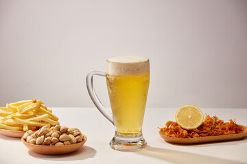 A glass of beer and fried potatoes spicy chicken floss in white background ,  mug of beer for food...