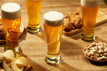 Drinking beer with fried potatoes spicy chicken floss and fried chicken in brown background , mug...