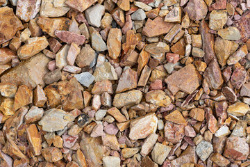 Large crushed stone for road construction close-up. Red rubble paving background.