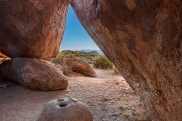 Ancient Native American mortar grinding stone in rock shelter at Council Rocks in the Dragoon Mountains in the Coronado National Forest, Arizona, USA