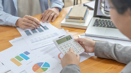 Brainstorm team, Marketers and financial accountants are discussing charts to plan strategies to meet customer needs, Using graphs to analyze business data, Meetings or business consulting.