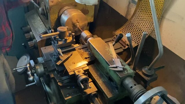 a man works on a lathe in a workshop. men's hands men's work lathe industry parts manufacturing soviet machine ussr