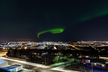 Mesmerizing shot of the northern lights over Reykjavik, Iceland