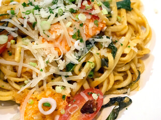 Homemade Lobster Linguine served on white plate. Lobster meat, dried chilies and cherry tomatoes mix together.