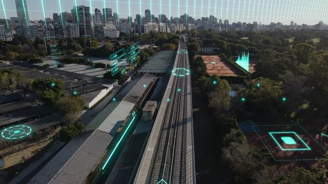 Aerial flyover railway tracks in digital modern city with high tech data communication - Neon lighting graph and diagram motion graphic with skyline of Buenos Aires in background during sunlight
