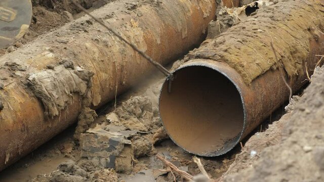 District heating pipeline under construction. Insulated steel pipe in deep trench. Reconstruction system