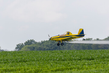 Airplane spraying fungicide on a soybean field, Marion County, Illinois