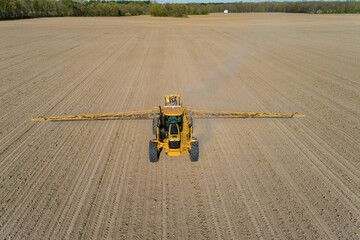 Aerial view of a sprayer applying chemicals to a corn field, Marion County, Illinois