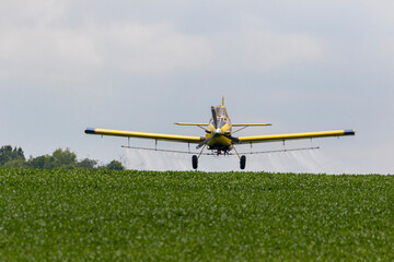 Airplane spraying fungicide on a soybean field, Marion County, Illinois