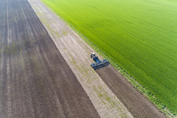 Aerial view of a tractor working the soil before planting, Marion County, Illinois