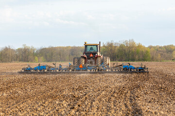 Tractor working the soil before planting, Marion County, Illinois