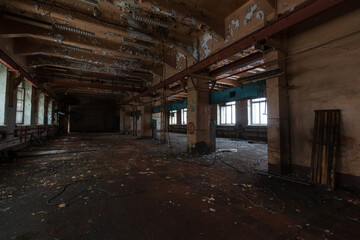 dark room of an abandoned building with windows