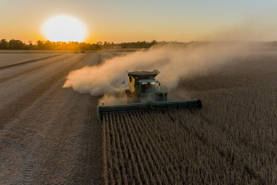 Aerial view of combines harvesting soybean field at sunset, Marion County, Illinois
