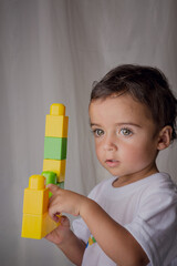 portrait of a little boy playing with building blocks