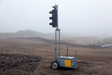 Umea, Norrland Sweden - August 28, 2019: temporary traffic light during road construction in fog
