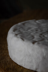 Homemade cheese with white mold. Macro photo. Front view.