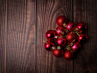 Christmas red ball on a wooden table. Holidays christmas background. Copy space for text or design. View from above.