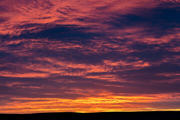 Sunrise skies from Freezeout Lake Wildlife Management Area looking to prairie near Choteau, Montana, USA