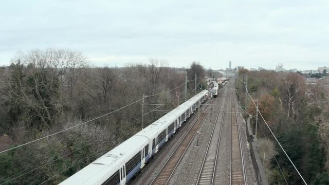 Overhead profile follow drone shot of elizabeth line TfL rail train