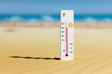 Sea coast at hot summer day. Fahrenheit scale thermometer in the sand shows plus 102 degrees