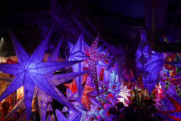 Christmas lights lightning paper lantern star hanging in Christmas market in Kerala India lots of...